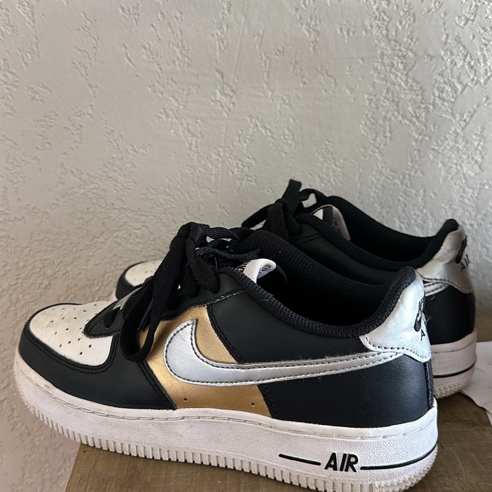 Nike Black and Gold Sneakers with Classic Air Force 1 Design